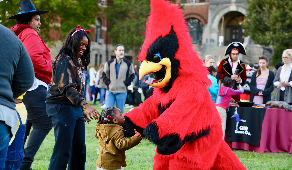 Red the Cardinal greets trick-or-treater